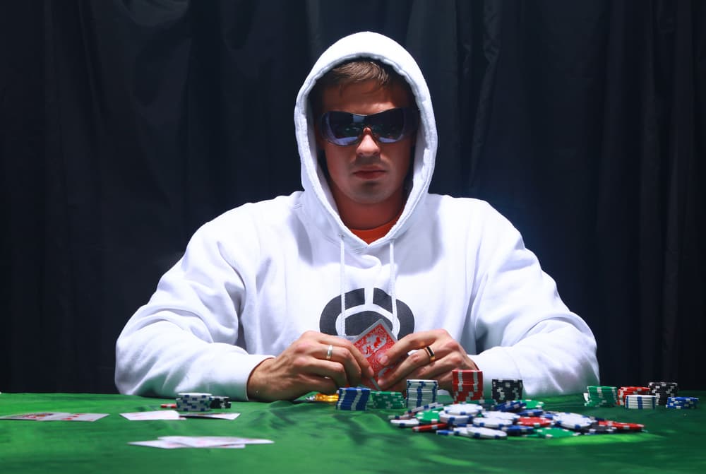 man playing poker, looking serious