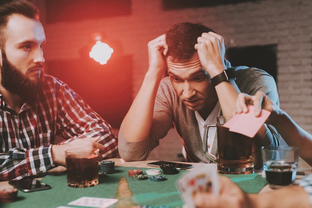 image shows man frustrated at a poker game